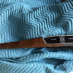 This is a Mercedes-Benz dashboard air vent trim panel with a wood grain finish.  It is compatible with Mercedes-Benz C-Class W204 models (2007-2014) a