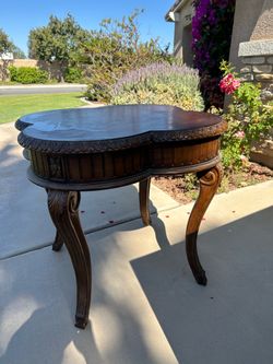 Wooden circular table with relief design.