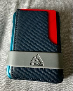 This is a Muradin V03 minimalist bifold card holder wallet featuring a sleek dark teal metal case and a black carbon fiber leather texture