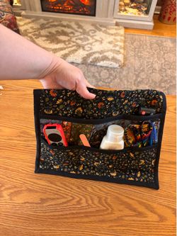 Brand new hand, quilted bed organizer or you can use the safety pin on it to put it onto your favorite chairs armrest