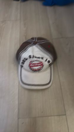 brown and white Red Stripe beer baseball cap