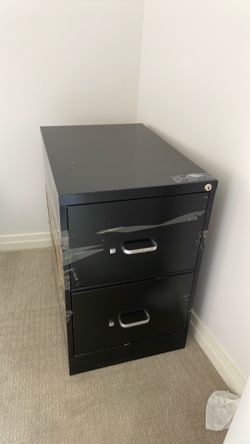 Filing cabinet with key and hanging folders.