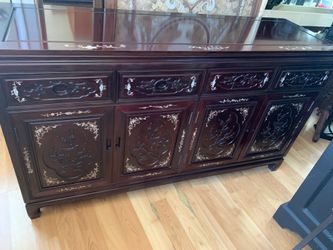 Mid-20 century dark rosewood sideboard with mother-of-pearl inlay and carved doors.