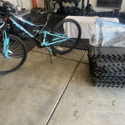 A Bike And A Stack Of Gym Mats 