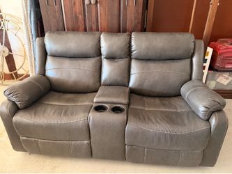 Brand new double reclining leather sofa with media console and cup holders