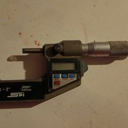 Mitutoyo 293-721-10 digital micrometer used for precise outside measurements.