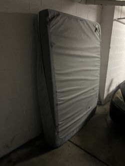 Queen Size Mattress Has A Mattress Cover Over It 
