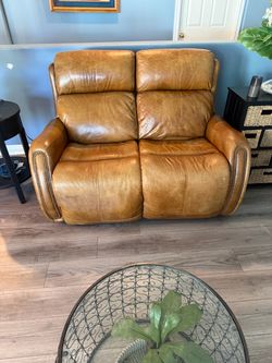 Brown cowhide Reclining Loveseat with Nailhead Trim