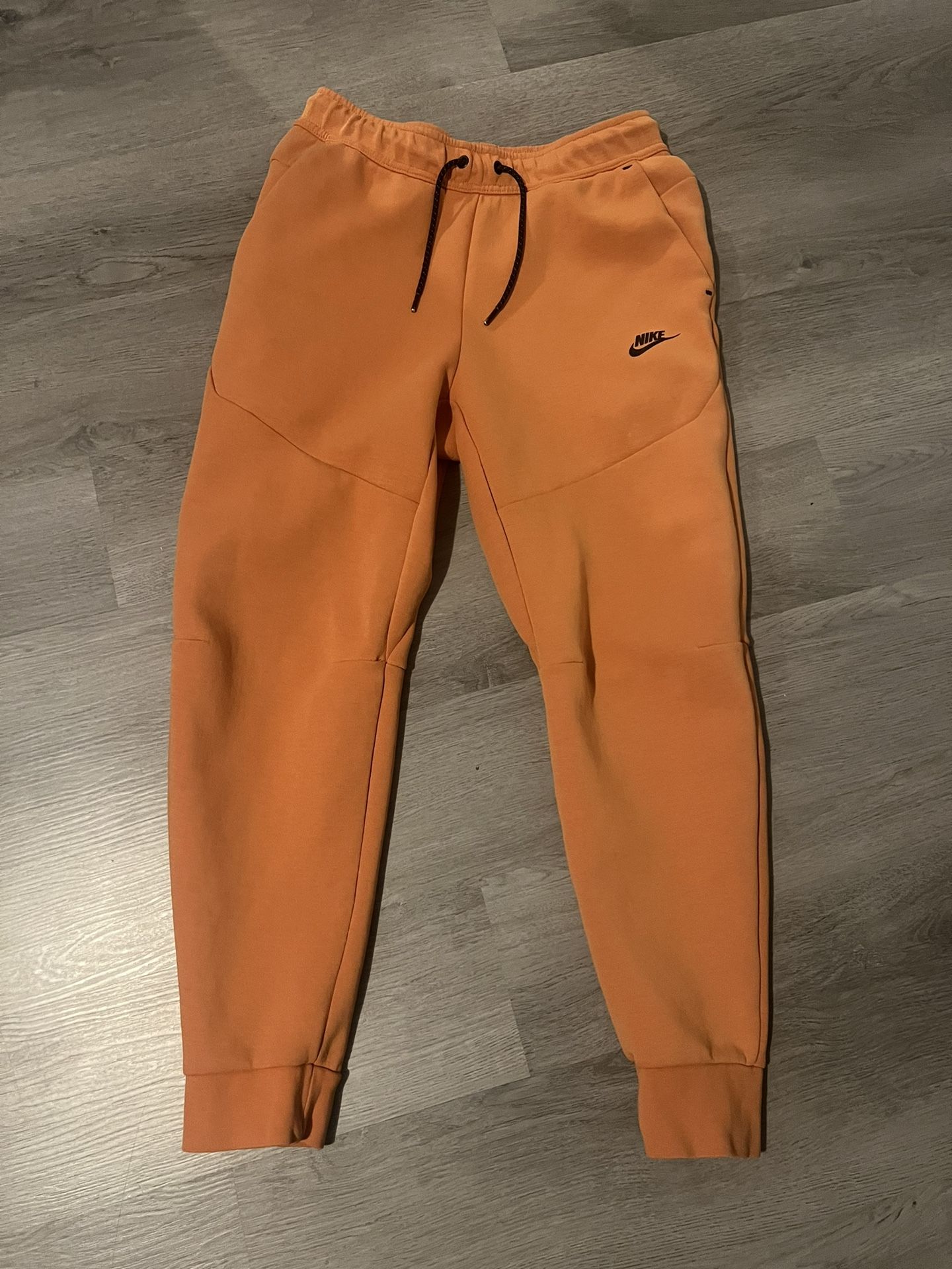 orange nike tech pants 