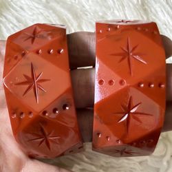 Gorgeous pair of Wide Rust Orange Bangle bracelets by Splendette! An orange colored bangle with carved dots and starbursts in a geometric shape. 