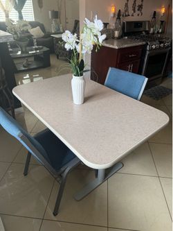 Table 48” x 30” and 29” high with 2 chairs in good condition