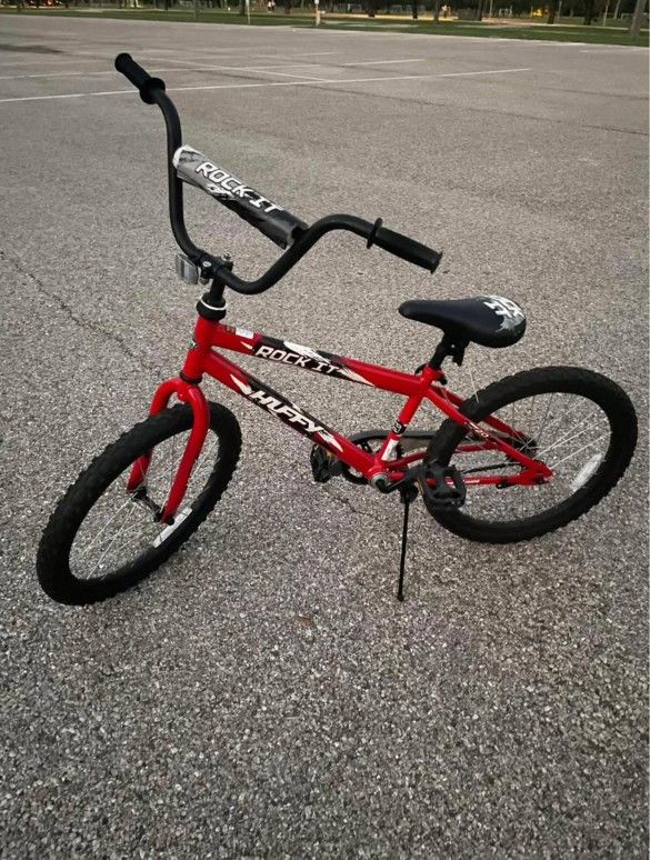 Huffy Rock 20 inch boys' bike, featuring a neon red frame with - Main Image