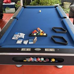 Pool table with cues, balls, and other accessories