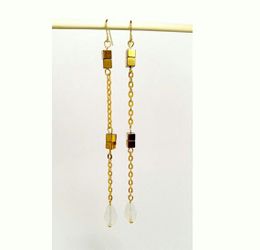 Simple and elegant long earrings with milky white tear drop crystal glass beads and golden colored cube beads
