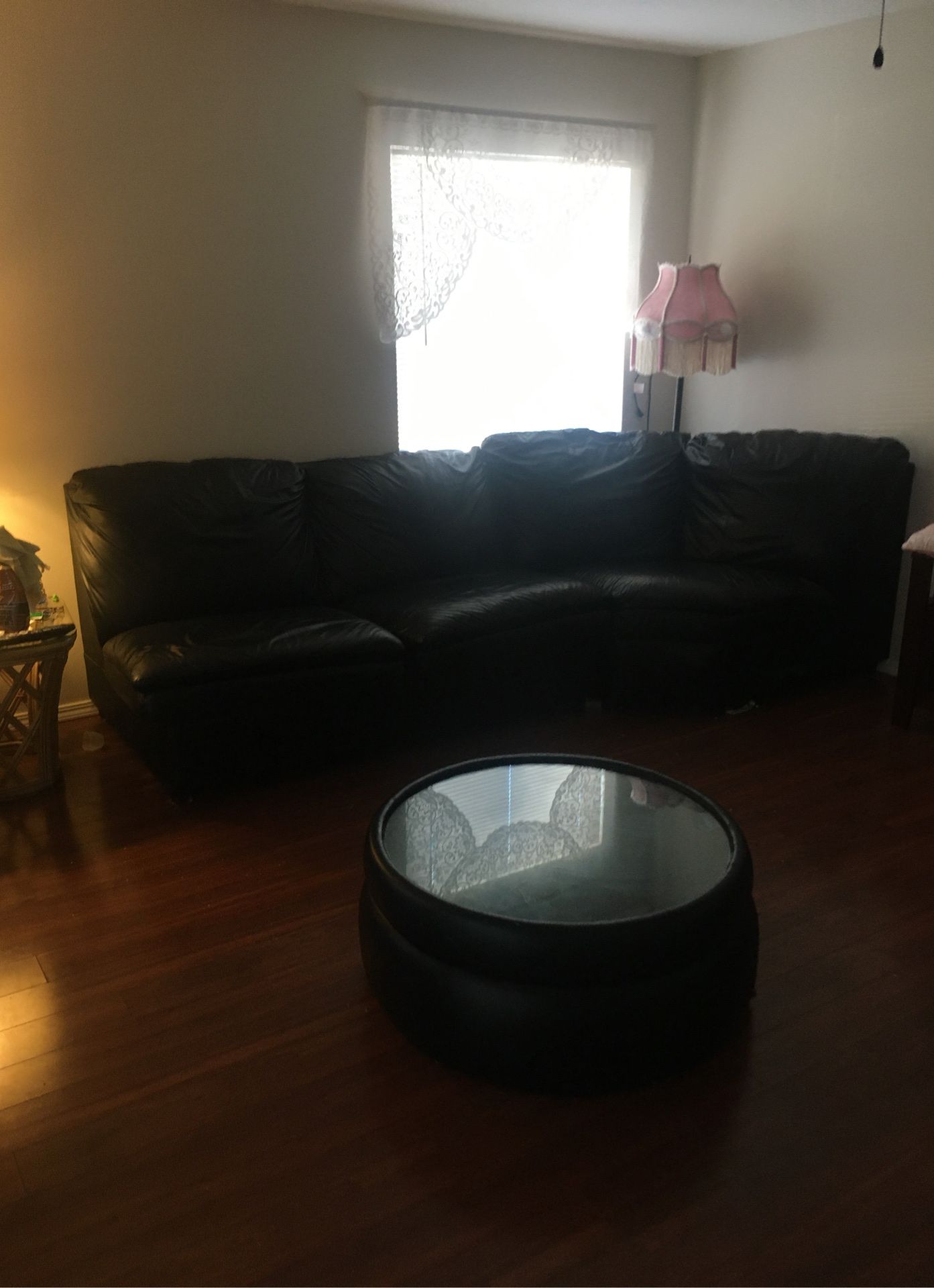 Beautiful black leather 4 piece sectional sofa with matching black leather glass table! Great condition! Sleep sofa!