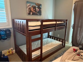 Wooden bunk beds for sale including mattresses.