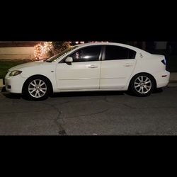 2008 mazda3 white 4 door/cylinder engine automatic transmission with gear shift.