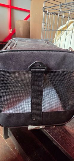 Pet carrier black with wool padding.