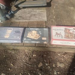 2 new 1 used wood mechanical puzzle sets, Great Condition. $20.00 for all.