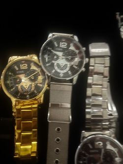 Diverse collection of wristwatches featuring stainless steel and gold-toned metal bands. The lot includes Eyros brand men's chronographs with black di