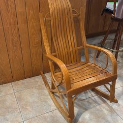 This Rocking Chair is an Amish Style Oak Brentwood Rocking Chair With Slatted Back and Seat