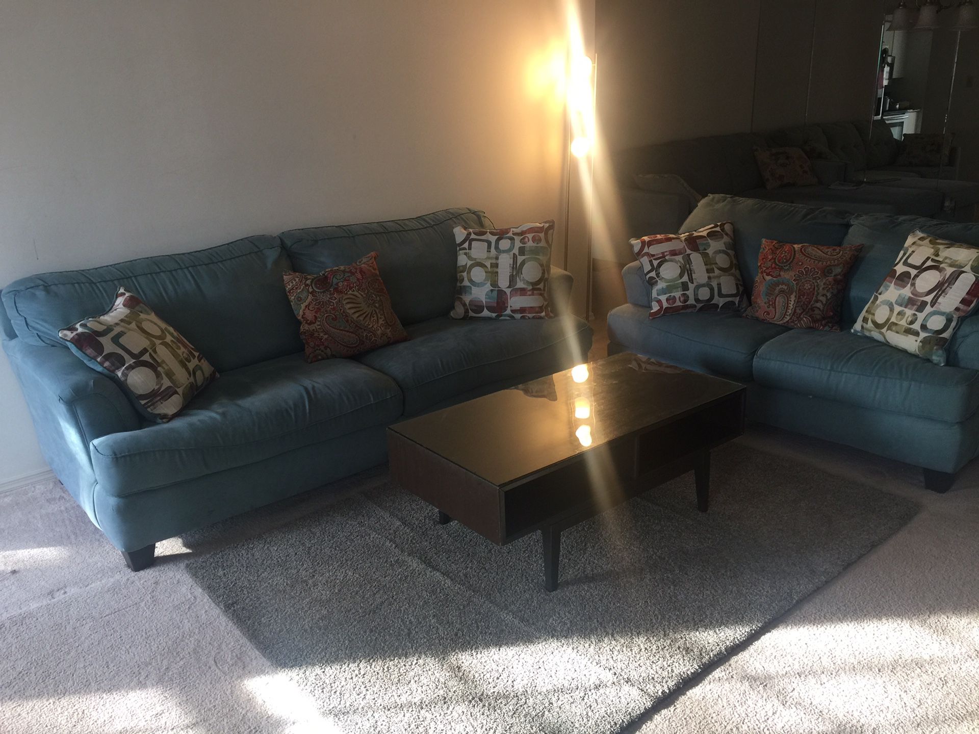 Two sofa, a coffee table, and blue rug.