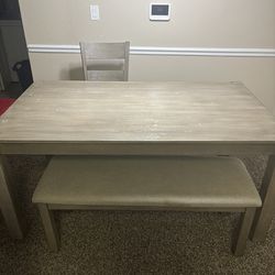 Used Table with two chairs and a bench
