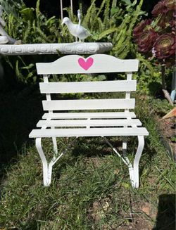 Small wooden bench with pink heart