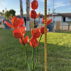  Iron hand-welded made orange tulips with green stems and a circular base for stability. designed for yard or garden decor.