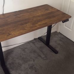 adjustable desk. can make taller or shorter with button on side, just need to plug into wall