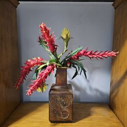 fake flowers in metal vase