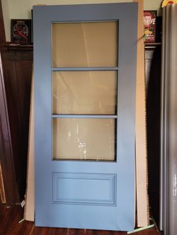 Light blue main door with clear glass