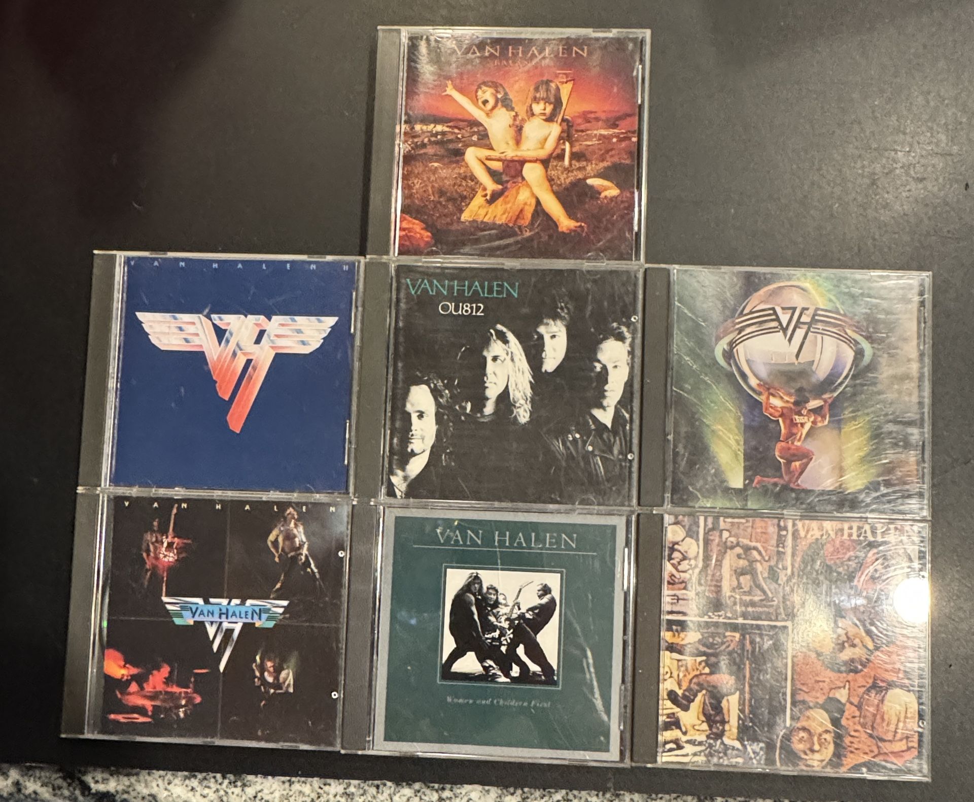 Van Halen CD Lot. 7 cds including OU812, 5150, Women and Children First, Van Halen II, Van Halen Self Titled, Balance, & Fair Warning. CDs all in good
