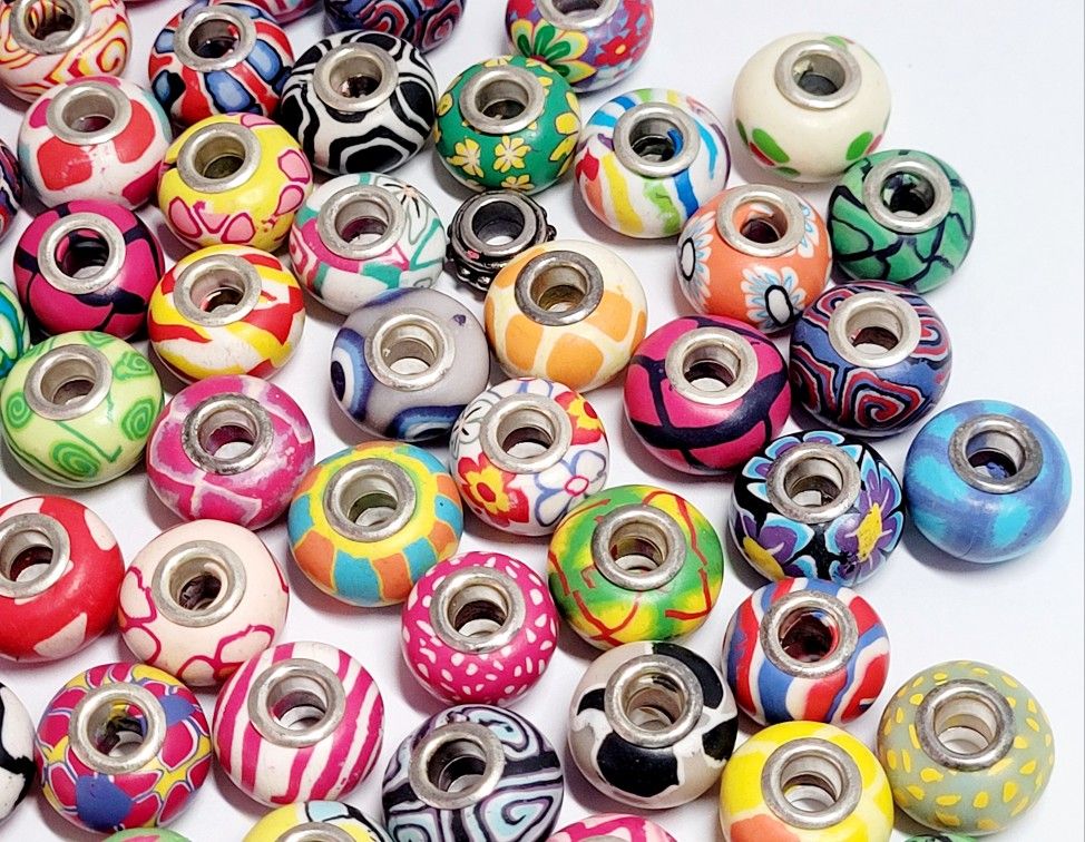 50pcs 11x16mm Clay Big Hole (5mm) Beads Assorted Colors & Design With Bracelet. The beads are made of clay.The core is made of silver plated copper. T