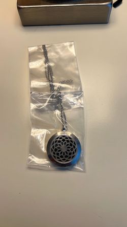Silver tone diffuser necklace- new in packaging