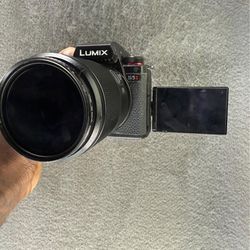Panasonic LUMIX s52 camera with two lens 3 batteries a battery charger a sd card  and a nd filter