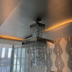 Gorgeous Riviera Chandelier W/ tiers of precision-cut crystals draping from a mirror-like stainless steel ribbon - Retail: $13,640