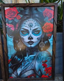 Framed picture of a woman with Catrina makeup.