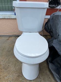Clean toilet in good condition; measures 17 inches high.