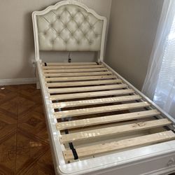 White twin bed with storage drawer