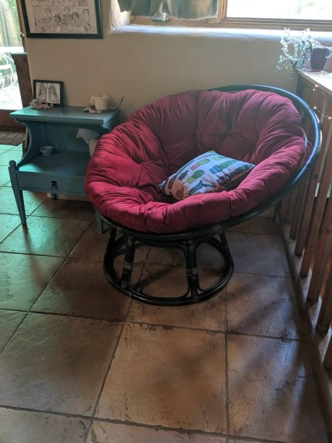 Papasan chair with red cushion