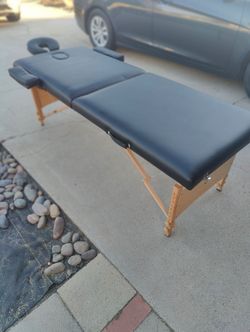 Massage table great condition black with wood legs