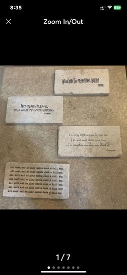 Four decorative stone tiles feature quotes from horror movie.