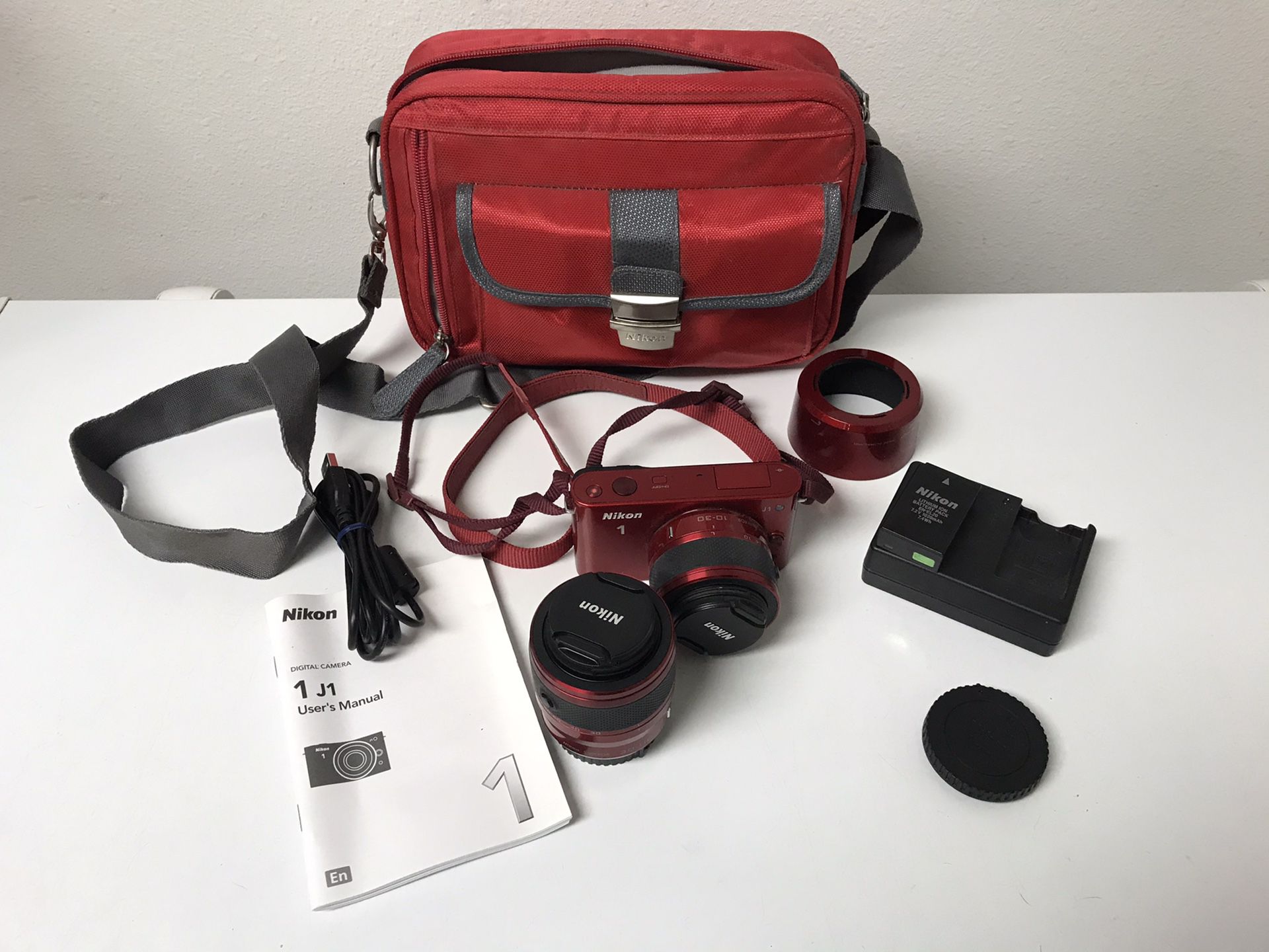 Nikon J1 camera complete w/ 2 interchangeable lenses(10-30mm & 30-110mm) lenses covers battery & charger, manual, usb cord, memory card, and Nikon ca