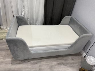 Gray upholstered toddler bed with mattress & topper