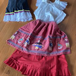 TWO LATINA OUTFITS ONE XS AND OTHER S - OUTFITS THE SAME BUT ONE HAS HAND EMBROIDERED APRON AND OTHER HAS LIGHT WOOL PONCHO BLACK WIT THIN WHITE TRIM 