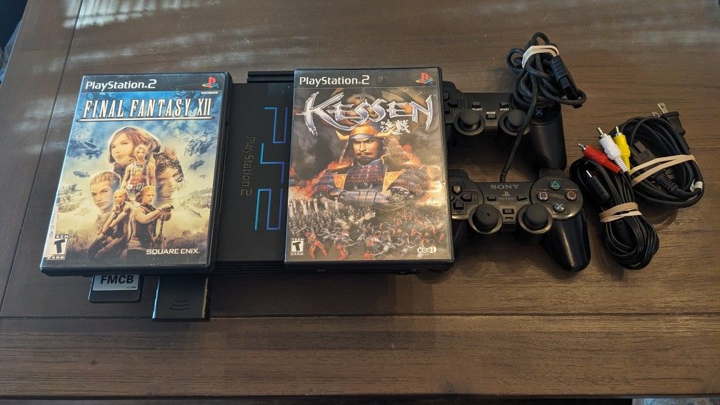 PlayStation 2 500GB Mcboot modded with 2 controllers, 1 wireless, cables and 2 games