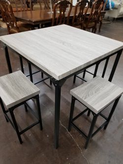 Grey counter height table with 4 stools