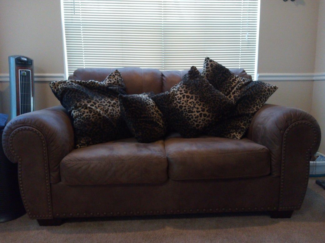 Pullout bed Couch,loveseat, & ottoman. Loveseat comes w/ pillows