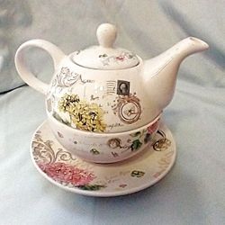 "Rosanna ""Primavera"" collectible teapot.,  Tea Party"" script, hydrangea flowers, vintage stamps, and 19th-century French/Italian inspired artwork. 